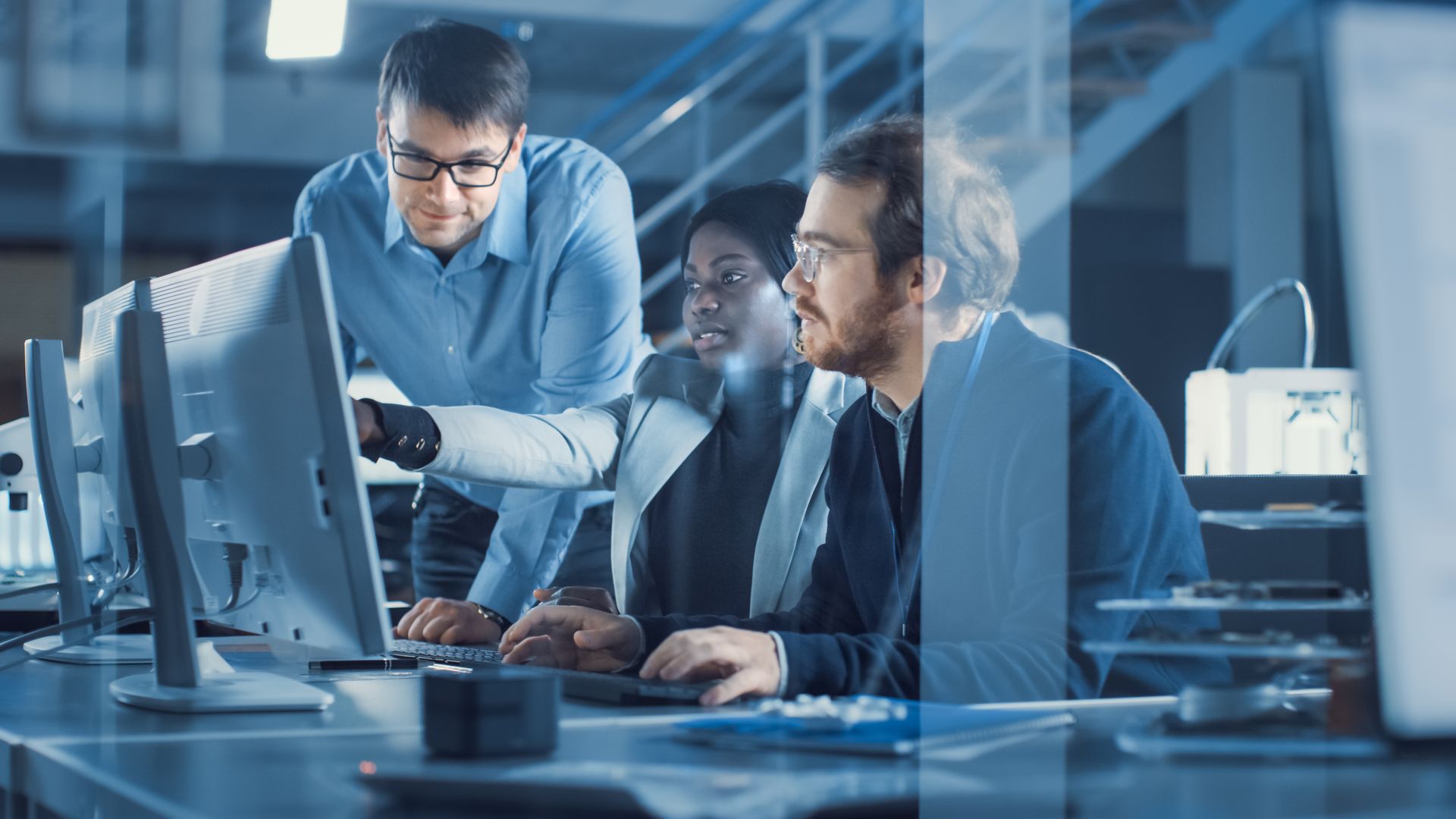 Engineers collaborating at a workstation