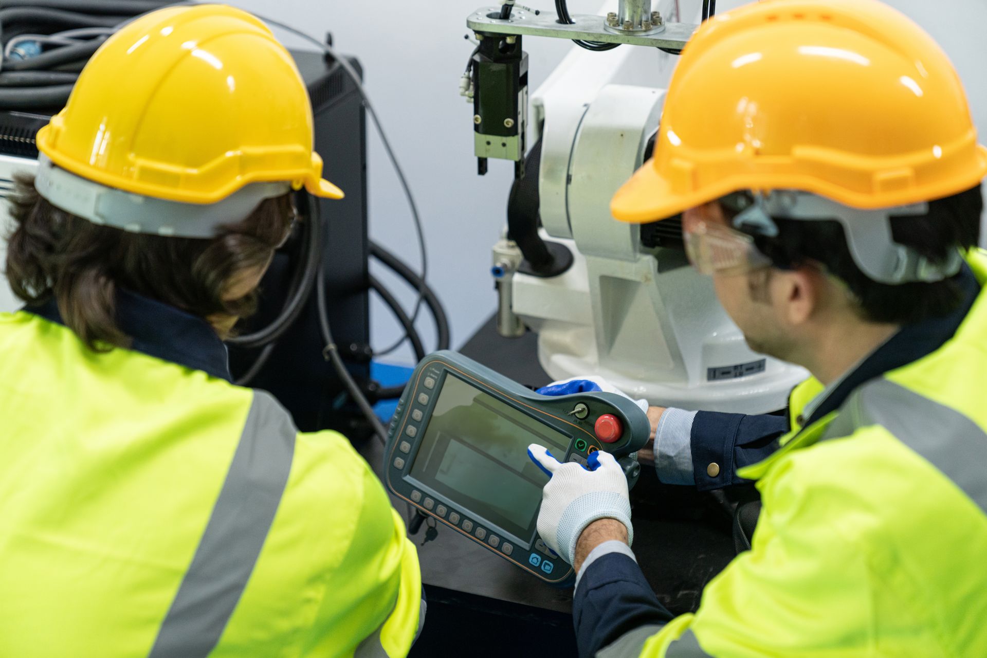 Two engineers programming a robot